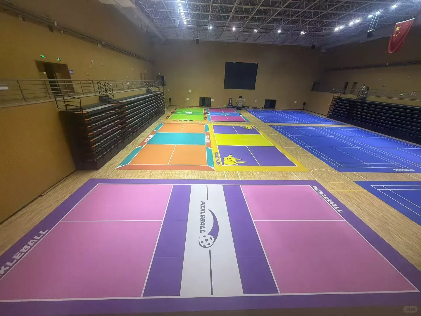 Rolled PVC sports flooring stored on racks in a climate-controlled warehouse